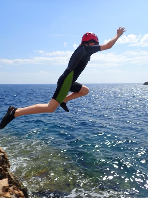 Kind springt von Klippe ins Wasser